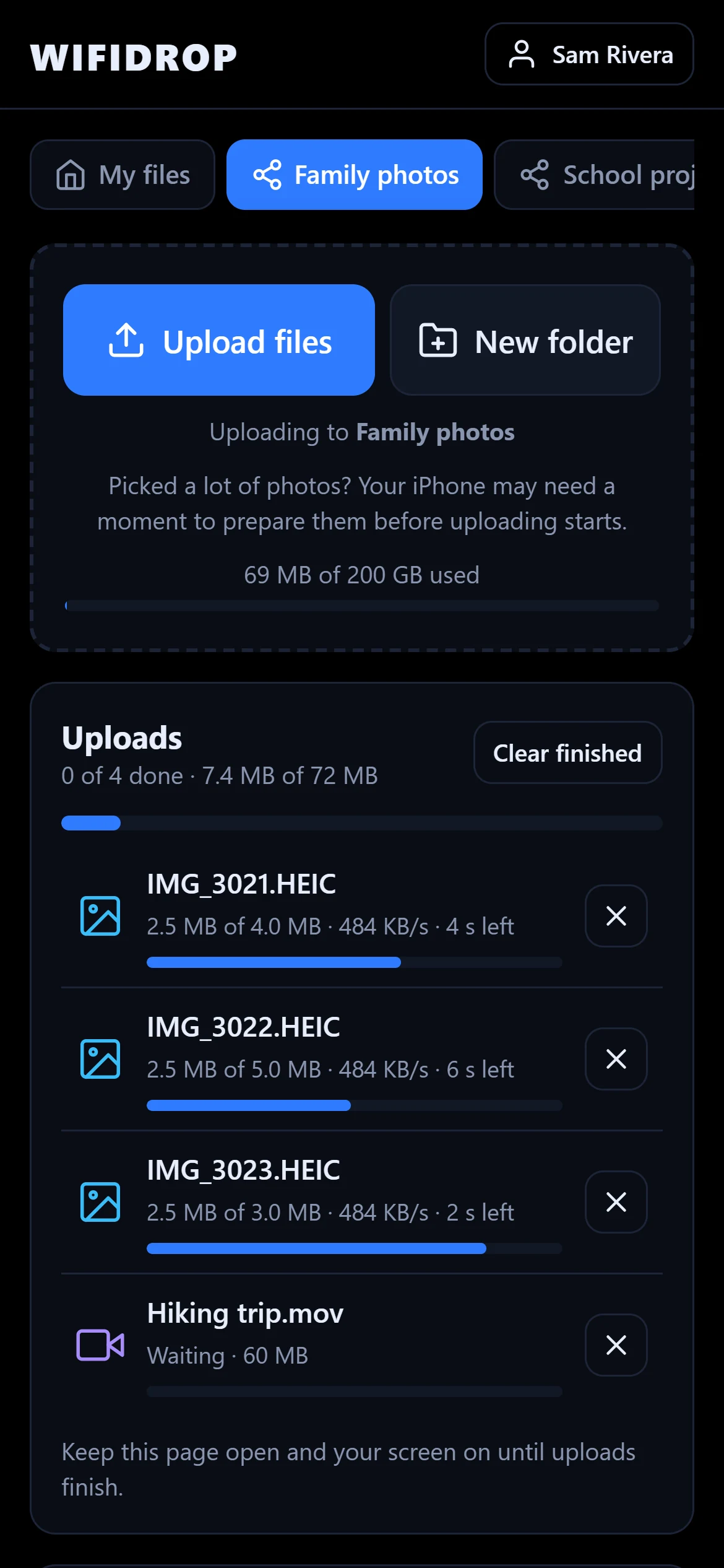A phone uploading four files with progress bars